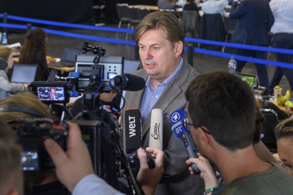 Maximilian Krah, the AfD's top candidate for the European elections, addresses the media during the European election meeting in Magdeburg, Germany, Sunday, Aug. 6, 2023. The 10-year-old Alternative for Germany, or AfD, gathered in the eastern city of Magdeburg for a convention stretching over two weekends at which it plans to choose candidates and set its policy platform for next June's European Parliament election. (Klaus-Dietmar Gabbert/dpa via AP)