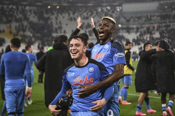 Napoli's Victor Osimhen, top, and Giacomo Raspadori celebrate their side's 1-0 win at the end of the Italian Serie A soccer match between Juventus and Napoli at the Allianz stadium in Turin, Italy, Sunday April 23, 2023. (Marco Alpozzi/LaPresse via AP)