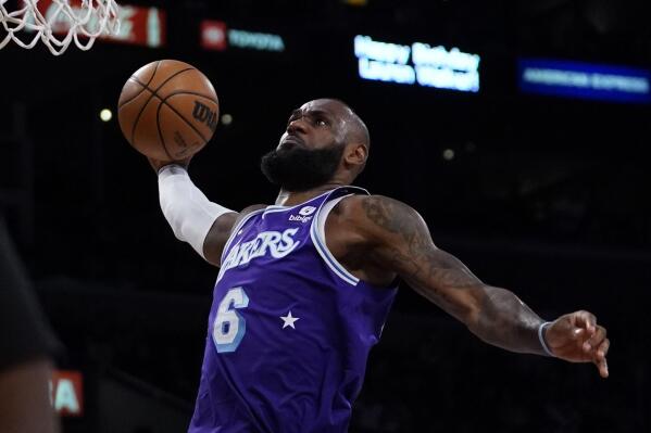 Los Angeles Lakers forward LeBron James (6) dunks during the first half of an NBA basketball game against the Washington Wizards in Los Angeles, Friday, March 11, 2022. (AP Photo/Ashley Landis)