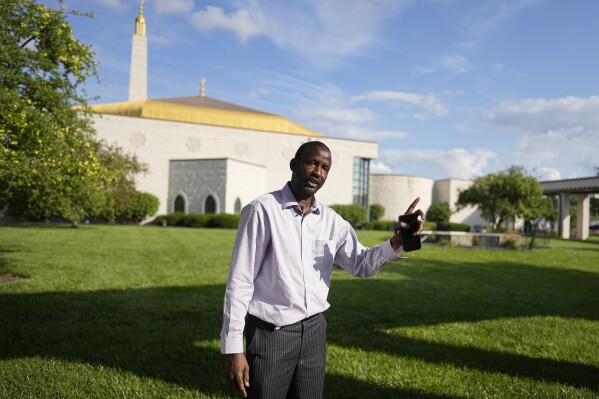 Oumar Ball speaks outside of the Islamic Center, Friday, July 21, 2023, in Cincinnati. Ball arrived in Cincinnati in 1997 and recently opened his home more than a dozen other new migrants also from Mauritania. (AP Photo/Darron Cummings)