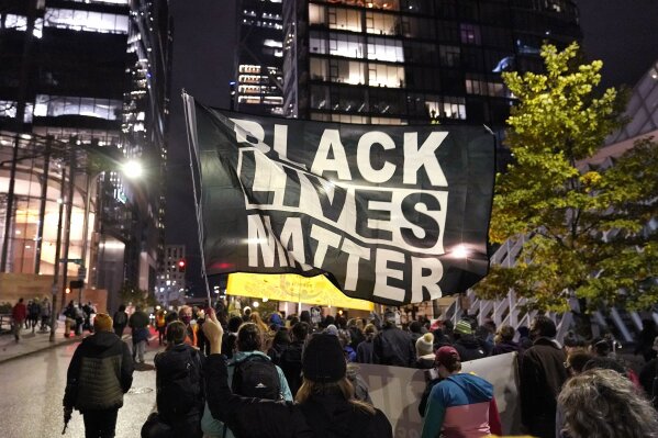 FILE - In this Nov. 4, 2020, file photo, protesters representing Black Lives Matter and Protect the Results march in Seattle. A financial snapshot shared exclusively with The Associated Press shows the Black Lives Matter Global Network Foundation took in just over $90 million last year. (AP Photo/Ted S. Warren, File)