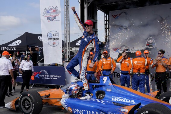 Scott Dixon celebrates after winning an IndyCar auto race at World Wide Technology Raceway, Sunday, Aug. 27, 2023, in Madison, Ill. (AP Photo/Jeff Roberson)