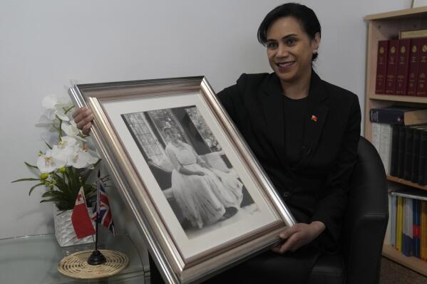 Tonga High Commissioner to the UK, Titilupe Fanetupouvava'u Tu'ivakano holds a portrait of her great grandmother Queen Salote Tupou III, during an interview with the Associated Press at the High Commission in London, Monday, May 30, 2022. As well as celebrating Queen Elizabeth II’s Platinum Jubilee, Tu’ivakano will also remember her great- grandmother Queen Salote Tupou III, who endeared herself to Britons as she rode through the streets of London in an open carriage during Elizabeth’s coronation parade in 1953. (AP Photo/Alastair Grant)