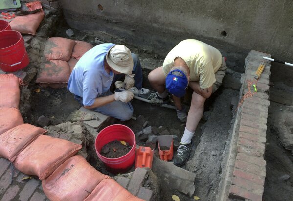 
              In this Sept. 28, 2017, photo, City of Boston Archaeological Program volunteers Tim Riordan, left, and Bob Sartini excavate a site that experts believe may have contained an outhouse used by Paul Revere. Fragments of pottery and a tobacco pipe already have been recovered from the dig outside the Pierce-Hichborn House in Boston's historic North End. Experts say the house, built next to Revere's house in 1711, was owned by one of Revere's cousins, and the renowned American patriot himself likely visited on numerous occasions. (AP Photo/William J. Kole)
            