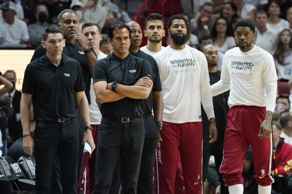 Miami Heat head coach Erik Spoelstra and his staff stand on the sidelines during the first half of Game 7 of the NBA basketball Eastern Conference finals playoff series against the Boston Celtics, Sunday, May 29, 2022, in Miami. (AP Photo/Lynne Sladky)