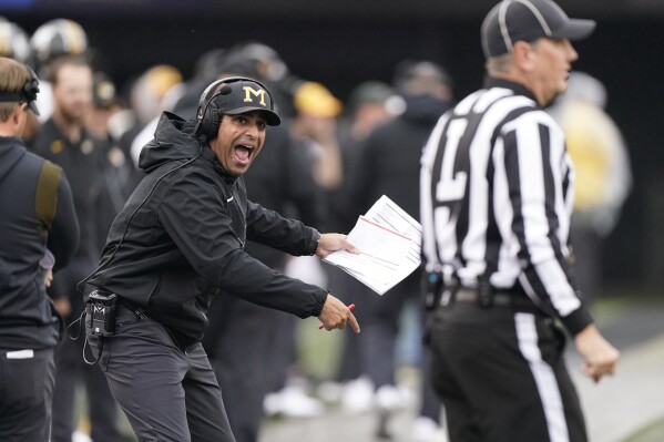 FILE - Bush Hamdan, left, Missouri receivers and quarterbacks coach, yells to an official during the first half of the team's NCAA college football game against Vanderbilt on Oct. 30, 2021, in Nashville, Tenn. Kentucky has Hamdan, most recently an assistant at Boise State, as offensive coordinator and quarterbacks coach following Liam Coen鈥檚 departure to the NFL鈥檚 Tampa Bay Buccaneers. (APPhoto/Mark Humphrey, File)