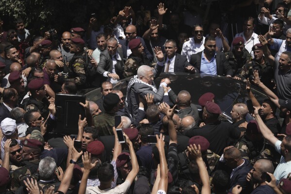 Palestinian President Mahmoud Abbas waves to well-wishers in the Jenin refugee camp in the West Bank, Wednesday, July 12, 2023. Abbas's visit — his first trip to the camp since 2005 — comes a week after a deadly Israeli offensive on Jenin that left widespread destruction in its wake. (AP Photo/Nasser Nasser)
