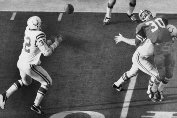 FILE - In this Jan. 17, 1971, file photo, Baltimore Colts linebacker Mike Curtis reaches for the ball to make an interception of a Dallas Cowboys pass intended for Dan Reeves (30) in the fourth period of  Super Bowl V in Miami, Fla. The first Super Bowl under the merger ended in high drama, but only after both teams struggled through 60 minutes of turnovers. (AP Photo, File)