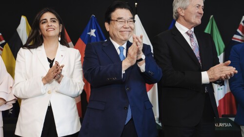 In this photo supplied by Smoke Photography, Claudia Sanhueza, left, under-secretary for International Economic Relations for Chile, Japan's Minister of Economic & Fiscal Policy Shigeyuki Goto and New Zealand Minister for Trade and Export Growth, Damien O'Connor, right, attend the Trans-Pacific Partnership (TPP) Ministerial Meeting in Auckland, New Zealand, Sunday, July 16, 2023. (Smoke Photography via AP)