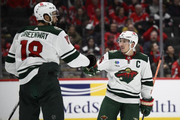 Minnesota Wild defenseman Jared Spurgeon (46) celebrates his goal with Minnesota Wild left wing Jordan Greenway (18) during the second period of an NHL hockey game against the Washington Capitals, Tuesday, Jan. 17, 2023, in Washington. (AP Photo/Nick Wass)