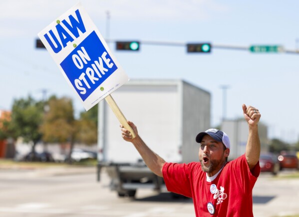 Co-chair of community service committee of UAW local 2360, Phillip Laws, reacts towards the ongoing traffic during a strike outside of Stellantis distribution center in Carrollton, Texas, on Friday, Sept. 22, 2023. (Shafkat Anowar/The Dallas Morning News via AP)