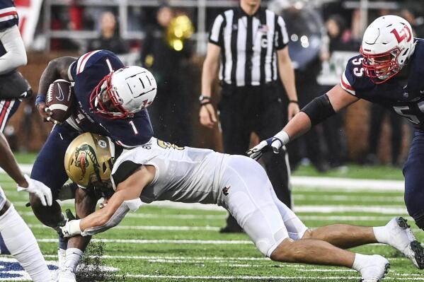 Liberty's Kaidon Salter, left, is tackled by UAB's Jackson Bratton during an NCAA college football game Saturday, Sept. 10, 2022, in Lynchburg, Va. (Paige Dingler/The News & Advance via AP)