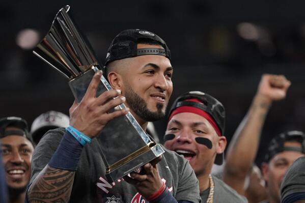 Atlanta Braves left fielder Eddie Rosario holds the Most Valuable Player trophy after winning Game 6 of baseball's National League Championship Series against the Los Angeles Dodgers Sunday, Oct. 24, 2021, in Atlanta. The Braves defeated the Dodgers 4-2 to win the series. (AP Photo/Ashley Landis)