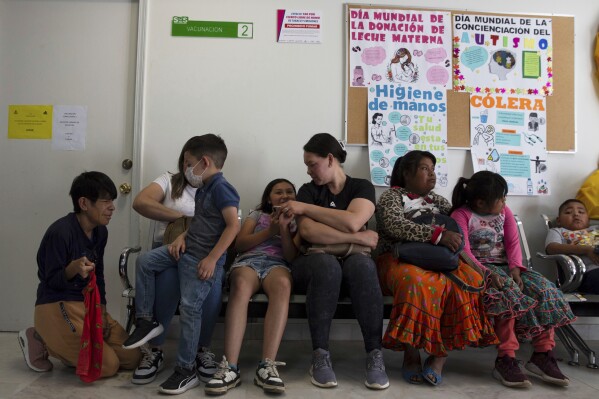 People wait to get vaccinated for measles at a health center in Cuauhtemoc, Chihuahua state, Mexico, Wednesday, April 30, 2025. (AP Photo/Megan Janetsky)
