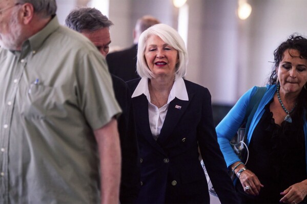 Former Mesa County, Colo., county clerk Tina Peters, center, arrives at the Mesa County Justice Center for her trial Monday, Aug. 12, 2024, in Grand Junction, Colo. (Larry Robinson/Grand Junction Sentinel via AP)