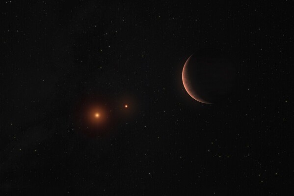 This artist’s illustration provided by the European Southern Observatory shows an exoplanet orbiting around two brown dwarfs, celestial objects that are lighter than stars, but heavier than gas giant planets. (M. Kornmesser/ESO via AP)