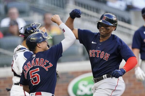 Boston Red Sox's Rafael Devers (11) celebrates with Enrique Hernandez (5) after hitting a three-run home run in the first inning of the team's baseball game against the Atlanta Braves Tuesday, June 15, 2021, in Atlanta. (AP Photo/John Bazemore)