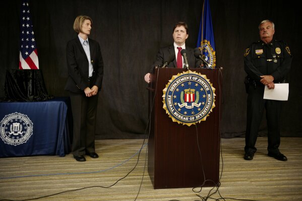 
              FBI Special Agent Jill Sanborn, left, and Grand Rapids Police Chief Scott Johnson, right, listen as U.S. Attorney Christopher Myers speaks during a news conference, Tuesday, Sept. 4, 2018, at the FBI office in Brooklyn Center, Minn., regarding the recovery of pair of ruby slippers once worn by actress Judy Garland in the "The Wizard of Oz." Authorities announced that the slippers, stolen in 2005 from the Judy Garland Museum in Grand Rapids, Minn., were recovered in a sting operation. The FBI says it has multiple suspects in the extortion and that the investigation continues. Four pairs of ruby slippers worn by Garland in the movie are known to exist. (Richard Tsong-Taatarii/Star Tribune via AP)
            