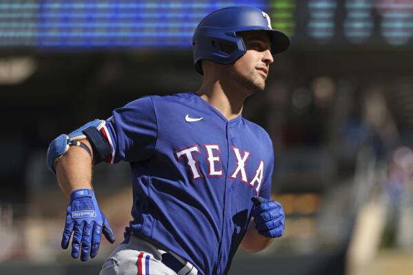 Texas Rangers' Brock Holt, left, and Isiah Kiner-Falefa, right, celebrate  Holt's walk-off single in the 11th inning of the team's baseball game  against the San Francisco Giants in Arlington, Texas, Wednesday, June