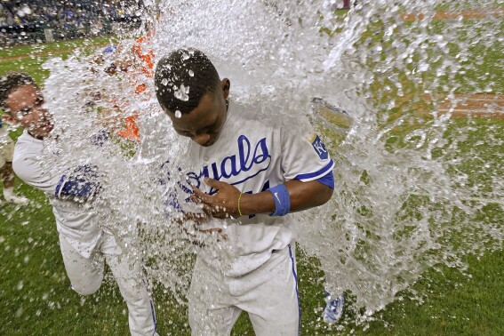 Kansas City Royals' Freddy Fermin, left, douses Dairon Blanco after their baseball game against the Seattle Mariners Monday, Aug. 14, 2023, in Kansas City, Mo. The Royals won 7-6. (AP Photo/Charlie Riedel)