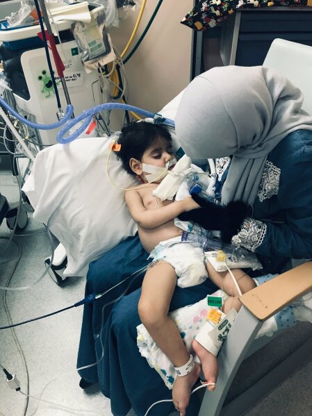
              In this December 2018 photo released by the Council on American Islamic Relations, Sacramento Valley, Shaima Swileh, of Yemen, holds her dying 2-year-old son Abdullah Hassan at UCSF Benioff Children's Hospital in Oakland, Calif.  The Council on American-Islamic Relations announced Friday, Dec. 28 that Abdullah died at the Oakland hospital, where his father Ali Hassan brought him in the fall to get treatment for a genetic brain disorder. Swileh, who is not an American citizen, sued the Trump administration to let her into the country to be with the ailing boy.   (Council on American Islamic Relations, Sacramento Valley via AP)
            