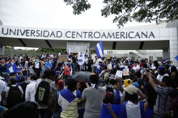 FILE - Demonstrators protest outside the Jesuit-run Universidad Centroamericana (UCA) demanding the university's allocation of its share of 6% of the national budget in Managua, Nicaragua, Aug. 2, 2018. Founded by Jesuits in 1960, UCA has historically rejected authoritarianism and offered support for students committed to fighting for deep social transformations. (AP Photo/Arnulfo Franco, File)
