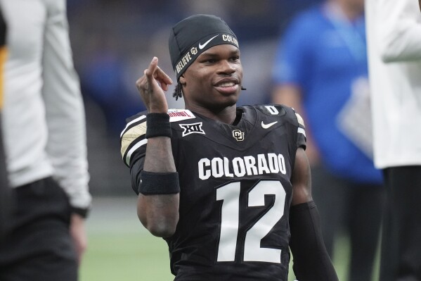 Colorado wide receiver Travis Hunter (12) warms up for the Alamo Bowl NCAA college football game against BYU, Dec. 28, 2024, in San Antonio. (AP Photo/Eric Gay, File)