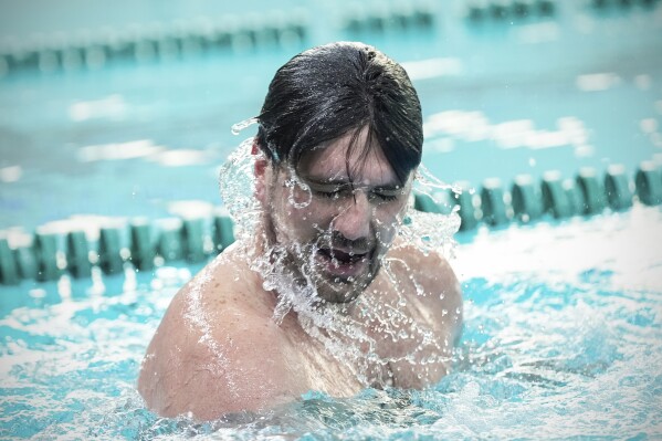 Damon LaSalle swims laps during a pool workout following practice, Friday, Feb. 21, 2025, at New Jersey City University in Jersey City, N.J. (AP Photo/Julia Demaree Nikhinson)