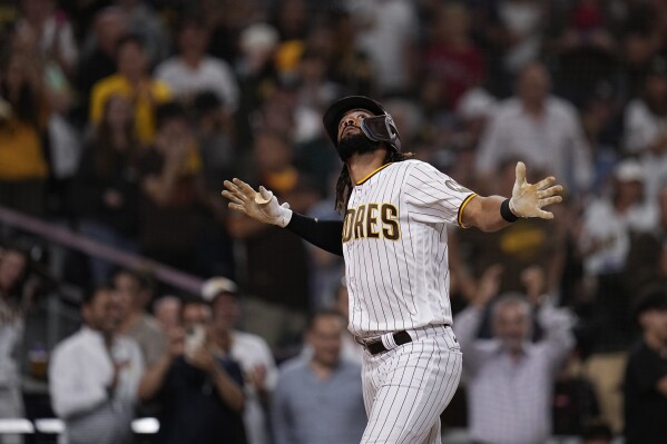 San Diego Padres' Fernando Tatis Jr., right, celebrates with Manny