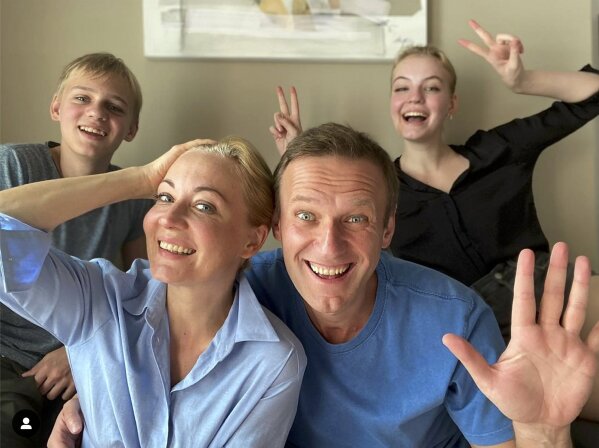 FILE - In this frame from video released on Dec. 31, 2020 by Russian opposition activist Alexei Navalny on his Instagram account, Navalny, foreground right, his wife Yulia, foreground left, his daughter Daria, right, and son Zakhar pose for a selfie. The return of Navalny from Germany on Jan. 17, 2021, after he spent five months in Berlin recovering from a nerve agent poisoning was marked by chaos and popular outrage, and it ended, almost predictably with his arrest. The flight carried him and his wife, along with a group of journalists documenting the journey. (Navalny Instagram account via AP, File)