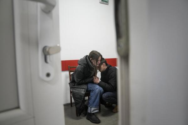 Marina Yatsko and her boyfriend Fedor comfort each other after her 18-month-old son Kirill was killed in shelling in a hospital in Mariupol, Ukraine, Friday, March 4, 2022. (AP Photo/Evgeniy Maloletka)