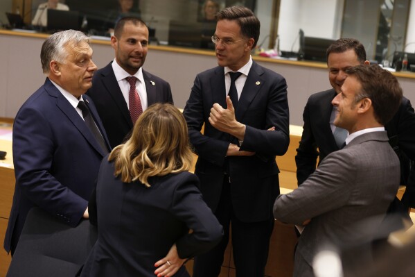 From left, Hungary's Prime Minister Viktor Orban, Malta's Prime Minister Robert Abela, Netherland's Prime Minister Mark Rutte, Portugal's Prime Minister Luis Montenegro, French President Emmanuel Macron and Italy's Prime Minister Giorgia Meloni speak during a round table meeting at an EU summit in Brussels, Wednesday, April 17, 2024. (AP Photo/Omar Havana)