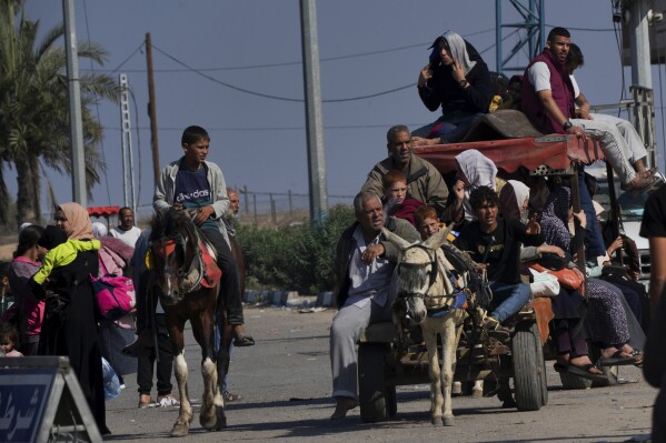 Palestinians flee to the southern Gaza Strip along Salah al-Din Street, on the outskirts of Gaza City, during the ongoing Israeli bombardment on Saturday, Nov. 18, 2023. (AP Photo/Adel Hana)