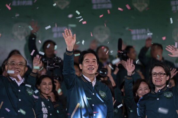 Taiwanese Vice President Lai Ching-te, also known as William Lai, left, celebrates his victory with running mate Bi-khim Hsiao in Taipei, Taiwan, Saturday, Jan. 13, 2024. The Ruling-party candidate has emerged victorious in Taiwan's presidential election and his opponents have conceded. (AP Photo/Louise Delmotte)