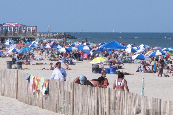 Beachgoers enjoy a sunny day on the beach in Point Pleasant Beach, N.J., on July 15, 2019. Point Pleasant Beach's mayor said on June 10, 2022, that it would join Long Branch, N.J., in seeking court orders to prevent so-called "pop-up parties" on its beachfront without prior approval by the local government. (AP Photo/Wayne Parry)