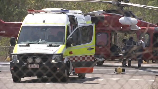 This image made from video shows a helicopter and ambulance involved in rescue mission, following an aircraft crash, in Darwin, Australia, Sunday, Aug. 27, 2023. Three United States military personnel were taken to a hospital, one with critical injuries, after a U.S. aircraft crashed on a north Australian island Sunday during a multination military exercise, officials said. (AuBC via AP)
