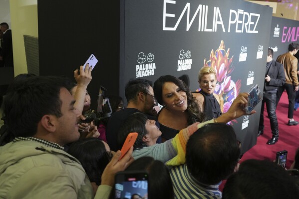 Actress Karla Sofia Gascon interacts with fans at a red carpet event to promote the film "Emilia Perez," in Mexico City, Wednesday, Jan. 15, 2025 (AP Photo/Eduardo Verdugo)