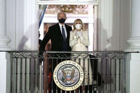 FILE - In this Wednesday, Jan. 20, 2021, file photo, President Joe Biden and first lady Jill Biden watch fireworks from the White House, in Washington. An interview with the Bidens appears in the Feb. 15, 2021, issue of People magazine, hitting newsstands nationwide Friday, Feb. 5. (AP Photo/Evan Vucci, File)