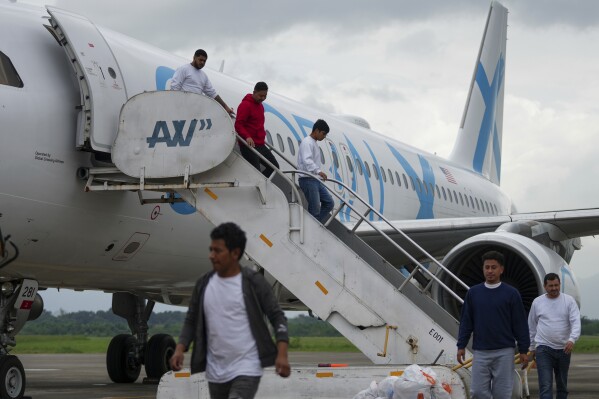 Honduras migrants who were deported from the U.S. deplane at Ramon Villeda Morales Airport, in San Pedro Sula, Honduras, Dec. 4, 2024. (AP Photo/Moises Castillo, File)