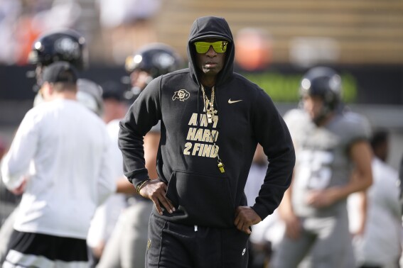 Colorado head coach Deion Sanders looks on as players warm up before an NCAA college football game against Southern California Saturday, Sept. 30, 2023, in Boulder, Colo. (AP Photo/David Zalubowski)