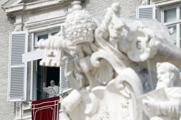 Pope Francis waves during the Angelus noon prayer delivered from his studio window overlooking St. Peter's Square, at the Vatican, Sunday, Oct. 4, 2020. (AP Photo/Gregorio Borgia)