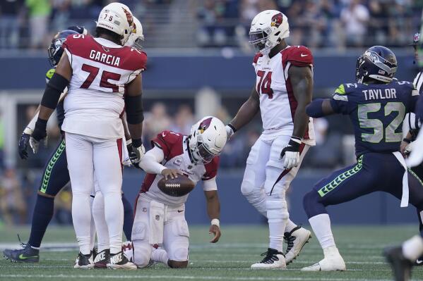 Arizona Cardinals quarterback Kyler Murray, bottom, reacts after being sacked against the Seattle Seahawks during the second half of an NFL football game in Seattle, Sunday, Oct. 16, 2022. (AP Photo/Abbie Parr)