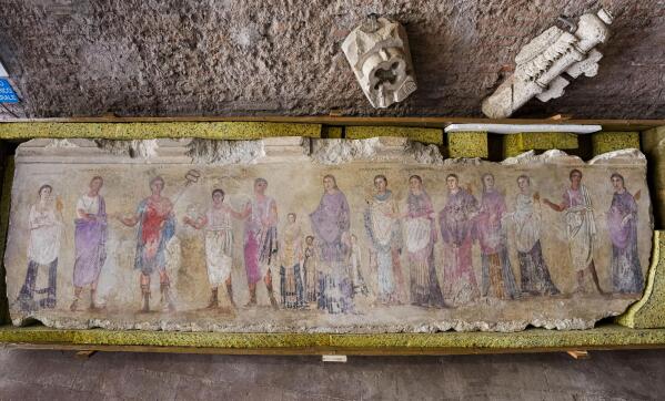 An undated fragment of a wall painting depicting deities and feminine figures and part of 750 archaeological finds from clandestine excavations on Italian territory is on display during a press conference in Rome, Wednesday, May 31, 2023. The set of artifacts, which can be dated overall between the eighth century BC. and the medieval period, and whose value is estimated at 12 million euros, was in possession of an English company in liquidation, Symes Ltd, attributable to Robin Symes, an important trafficker of cultural assets, and was repatriated from London on 19 May. (AP Photo/Domenico Stinellis)