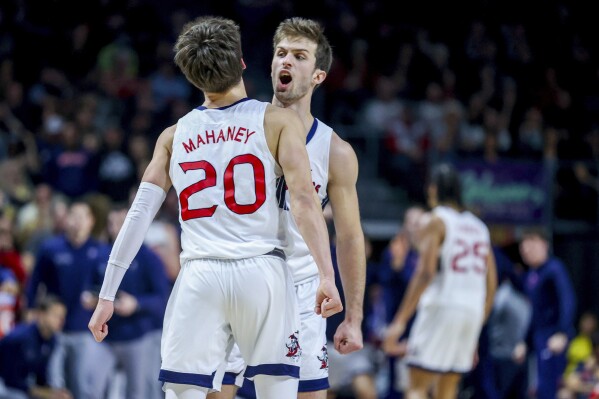 Saint Mary's guards Aidan Mahaney (20) and Augustas Marciulionis (3) celebrate during the second half of the team's NCAA college basketball game against Gonzaga for the championship of the West Coast Conference men's tournament Tuesday, March 12, 2024, in Las Vegas. (AP Photo/Ian Maule)