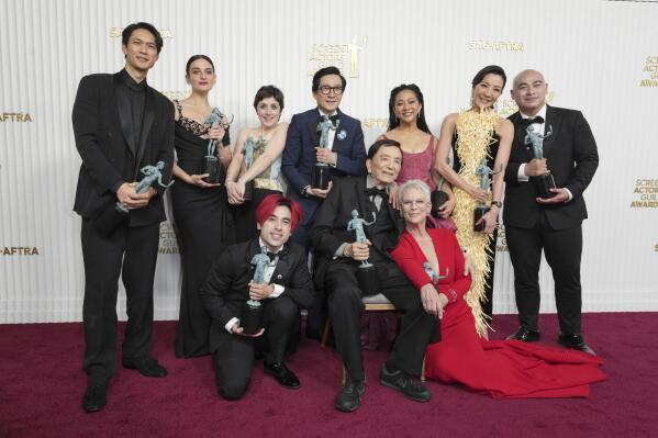 Harry Shum Jr., from back left, Jenny Slate, Tallie Medel, Ke Huy Quan, Stephanie Hsu, Michelle Yeoh, Brian Le, Andy Le, from front left, James Hong, and Jamie Lee Curtis pose with the award for outstanding performance by a cast in a motion pictures for "Everything Everywhere All at Once," in the press room at the 29th annual Screen Actors Guild Awards on Sunday, Feb. 26, 2023, at the Fairmont Century Plaza in Los Angeles. (Photo by Jordan Strauss/Invision/AP)