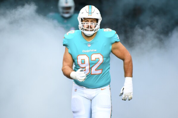 FILE -Miami Dolphins defensive tackle Zach Sieler (92) is introduced to the fans and runs onto the field before an NFL football game against the Green Bay Packers, Sunday, Dec. 25, 2022, in Miami Gardens, Fla. The Miami Dolphins announced Sunday that they have signed defensive tackle Zach Sieler to a contract extension through the 2026 season, Sunday, Aug. 27, 2023. (AP Photo/Doug Murray, File)
