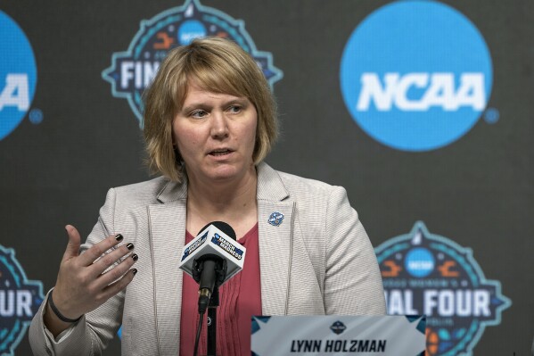 FILE - Lynn Holzman, NCAA vice president for women's basketball, speaks during a news conference Wednesday, March 30, 2022, in Minneapolis. The NCAA women's basketball tournament has so far been the most successful its ever been in regards to attendance and viewership. Still a few problems have arisen off the court that have taken away a bit from the success. (Elizabeth Flores/Star Tribune via AP, File)