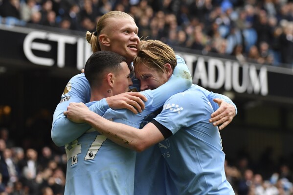 Manchester City's Erling Haaland celebrates with his teammates after scoring his side's second goal during the English Premier League soccer match between Manchester City and and Everton, at the Etihad stadium in Manchester, England, Saturday, February 10, 2024. (APPhoto/Rui Viera)