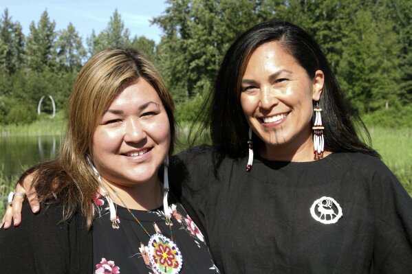 In this June 19, 2019, photo, Rochelle Adams, left, an Alaska Native cultural advisor, and Princess Johnson, the creative producer for the series "Molly of Denali" appear at the Alaska Native Heritage Center in Anchorage, Alaska. The animated show, which highlights the adventures of a 10-year-old Athabascan girl, Molly Mabray, premieres July 15 on PBS Kids. (AP Photo/Mark Thiessen)