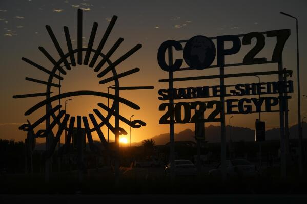The sunsets behind the COP27 logo outside the venue of the COP27 U.N. Climate Summit, Saturday, Nov. 12, 2022, in Sharm el-Sheikh, Egypt. (AP Photo/Peter Dejong)
